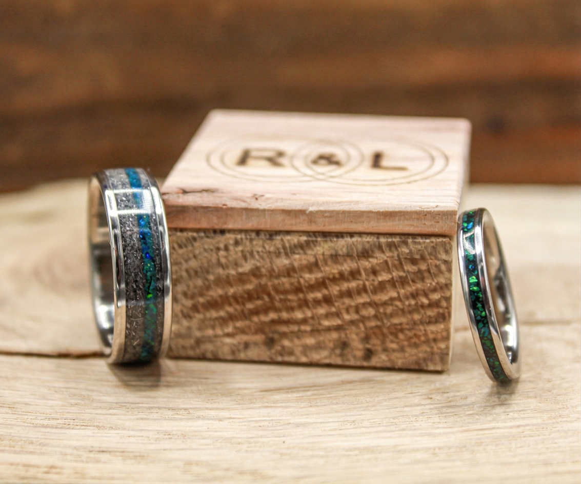 Handcrafted wedding rings with meteorite and opal on wooden ring box