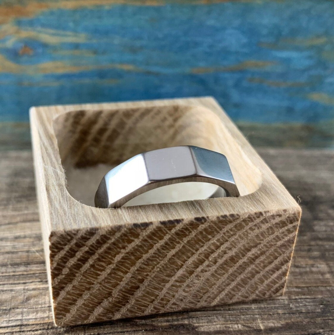  Handcrafted titanium ring has ten equal sides. Sleek and classic looking.