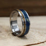 Men's titanium wedding band with dinosaur bone and blue wood. Blue wood ring. Titanium Ring. Dinosaur bone ring.