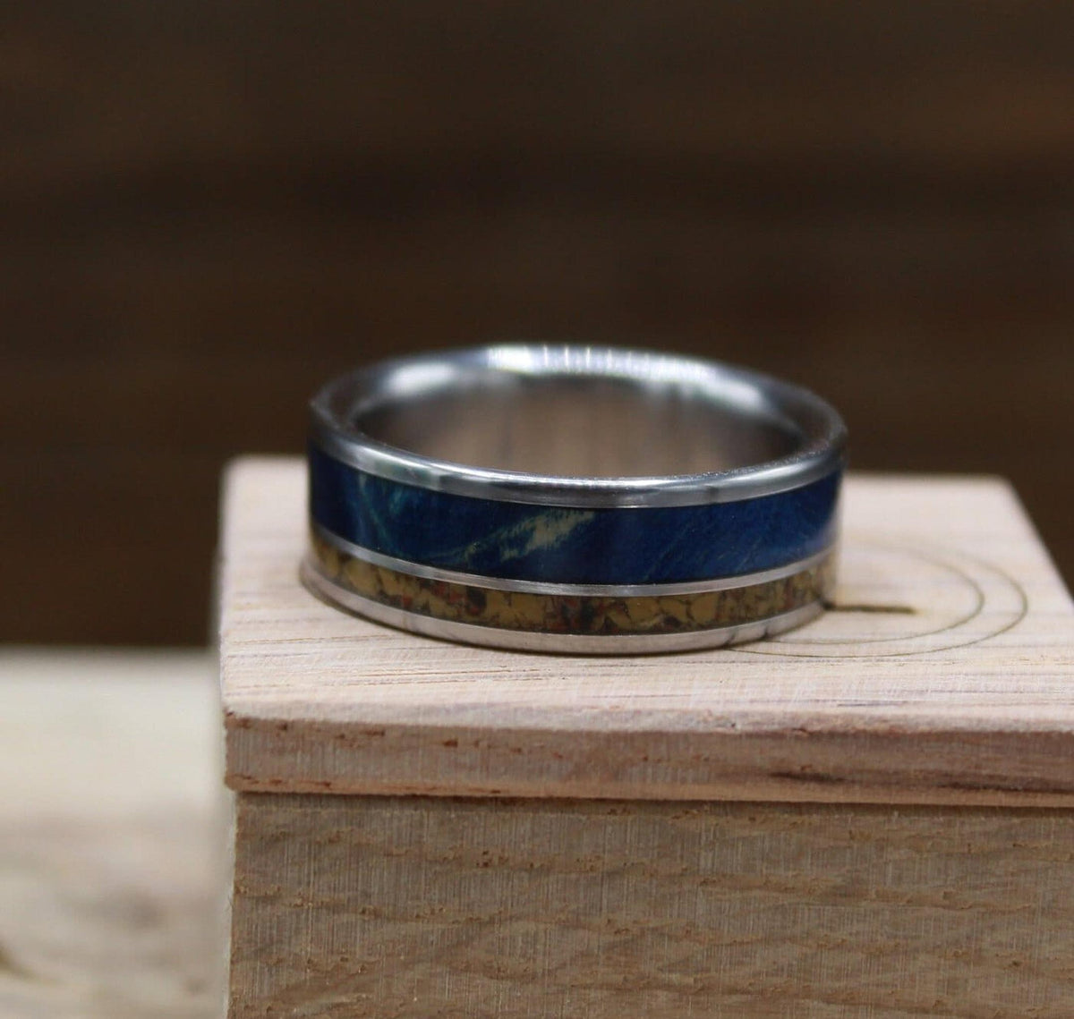 Men's titanium wedding band with dinosaur bone and blue wood. Blue wood ring. Titanium Ring. Dinosaur bone ring.