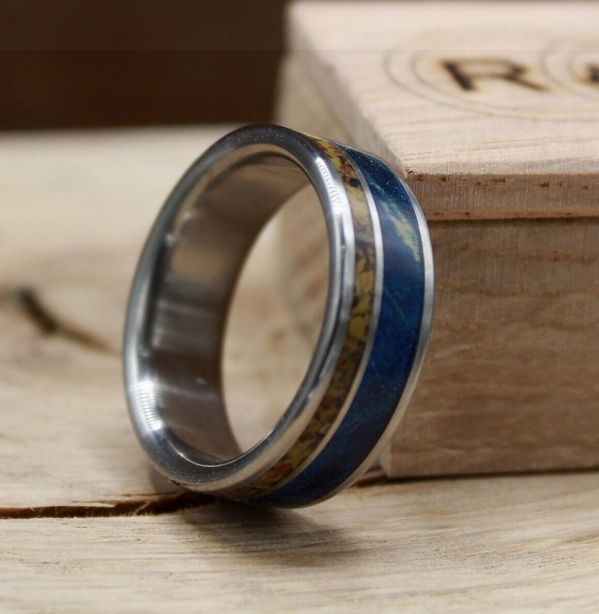 Men's titanium wedding band with dinosaur bone and blue wood. Blue wood ring. Titanium Ring. Dinosaur bone ring.