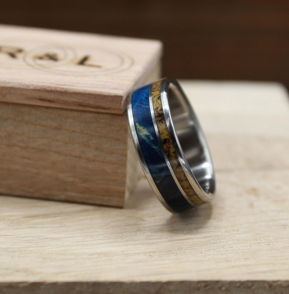 Men's titanium wedding band with dinosaur bone and blue wood. Blue wood ring. Titanium Ring. Dinosaur bone ring.