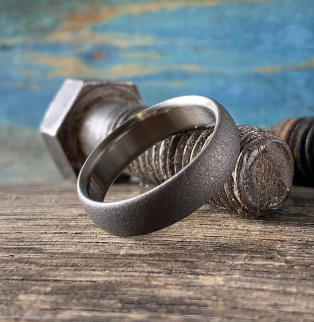 Side profile of sandblasted titanium wedding band showing thickness and dome curve