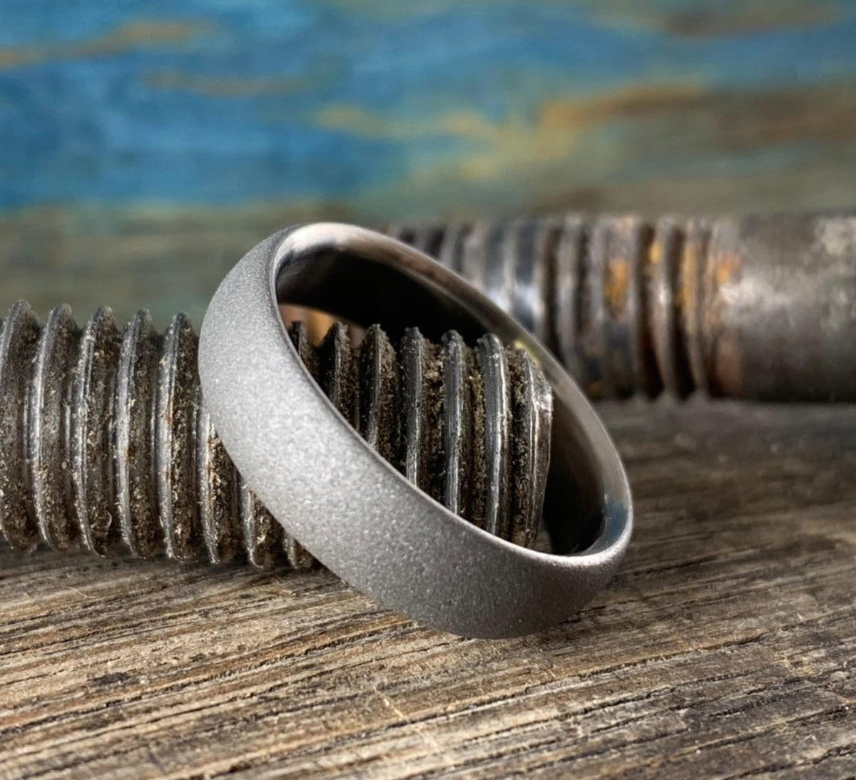 Close-up of matte sandblasted titanium ring texture and comfort-fit edge