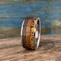 A silver-colored ring with a hammered texture on the outer edges, a smooth copper-colored band, and a textured yellow-orange band in the center.