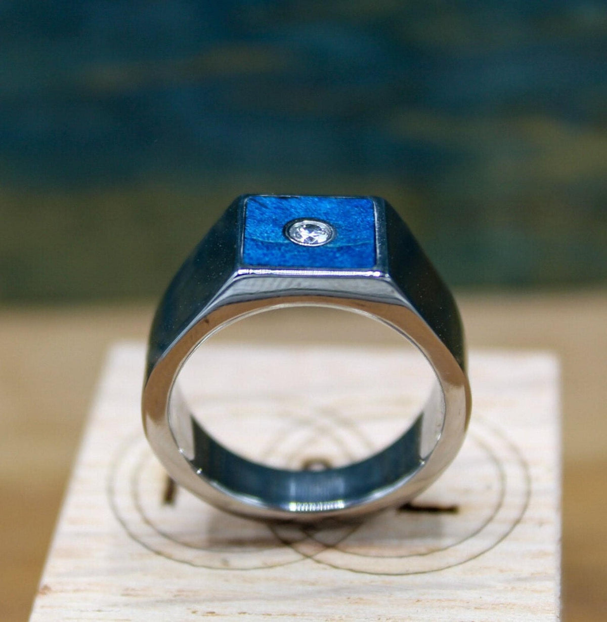Custom made men's signet ring with blue box elder wood and bezel set moissanite.