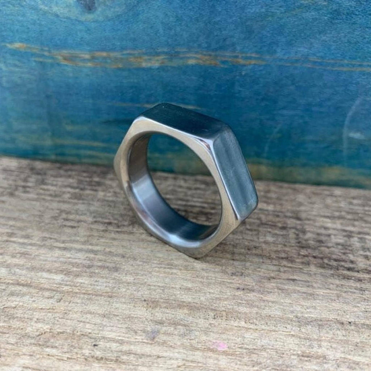 A perspective shot of the angular metallic ring on a wooden table.