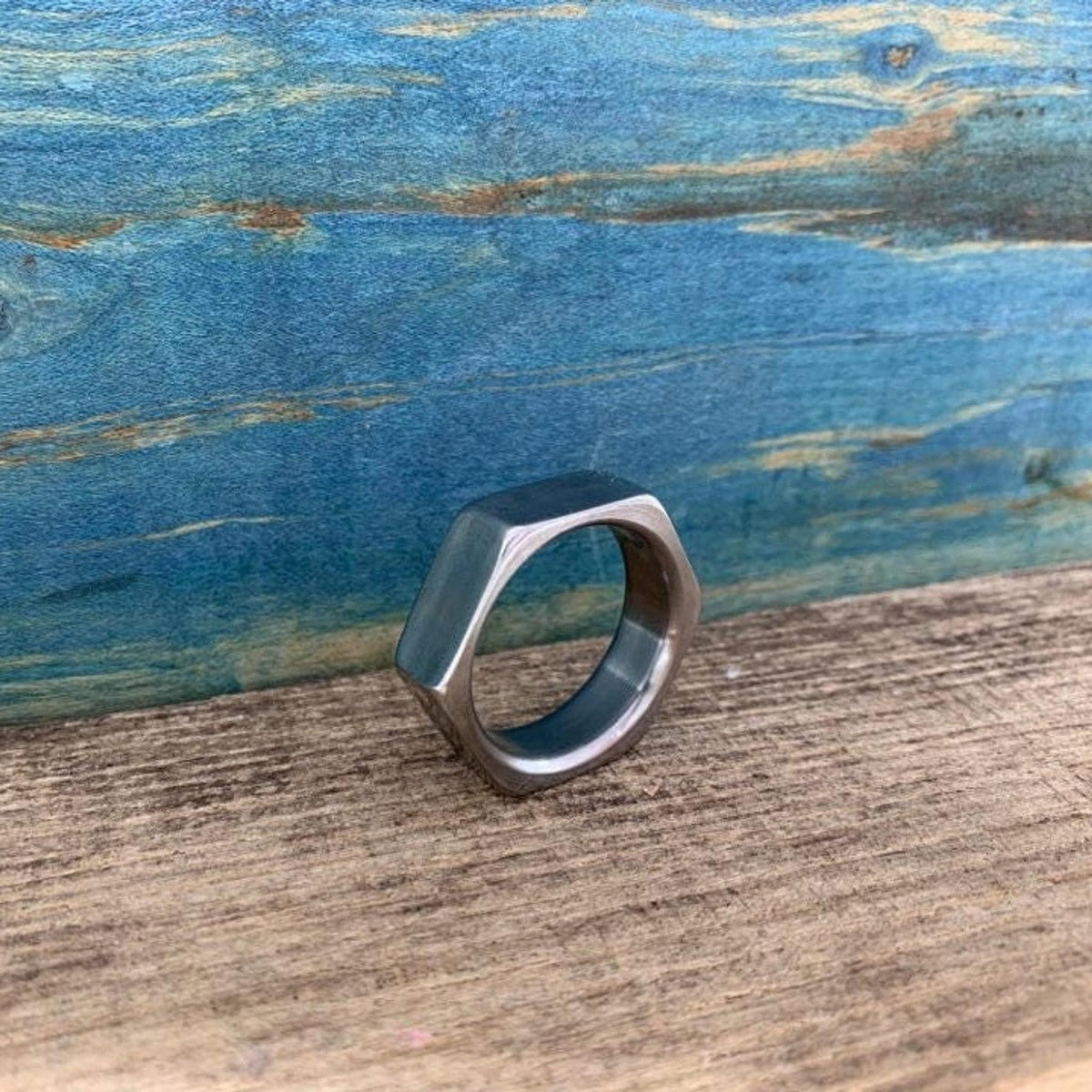 An angled view of the metal ring highlighting its flat hexagonal faces.