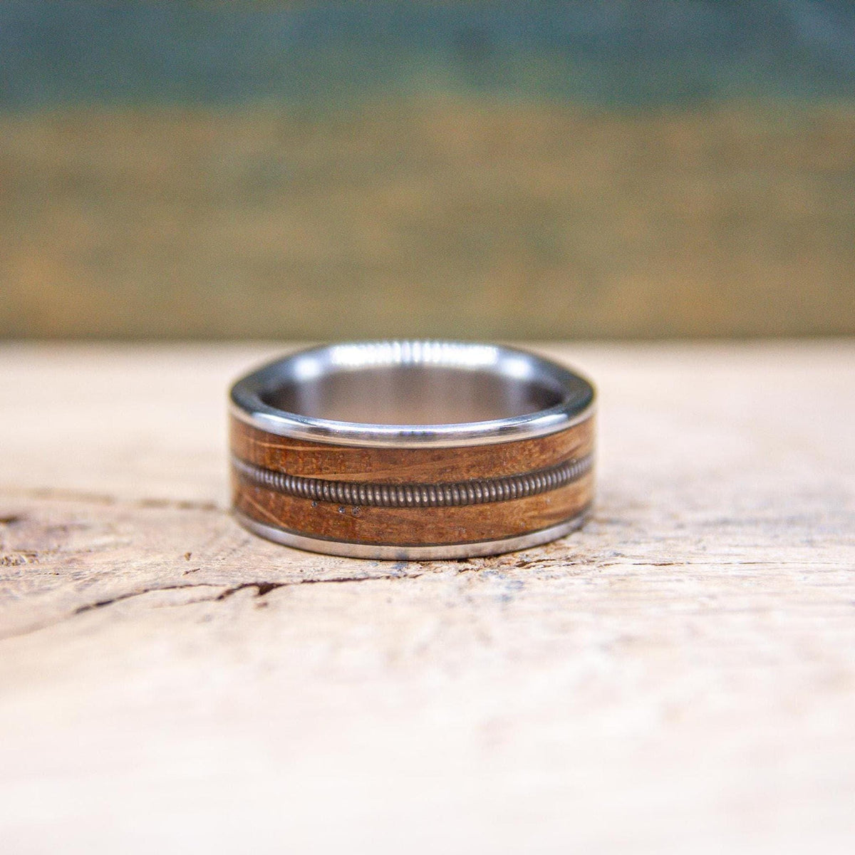 Side view of titanium ring with reclaimed wood and guitar string inlay