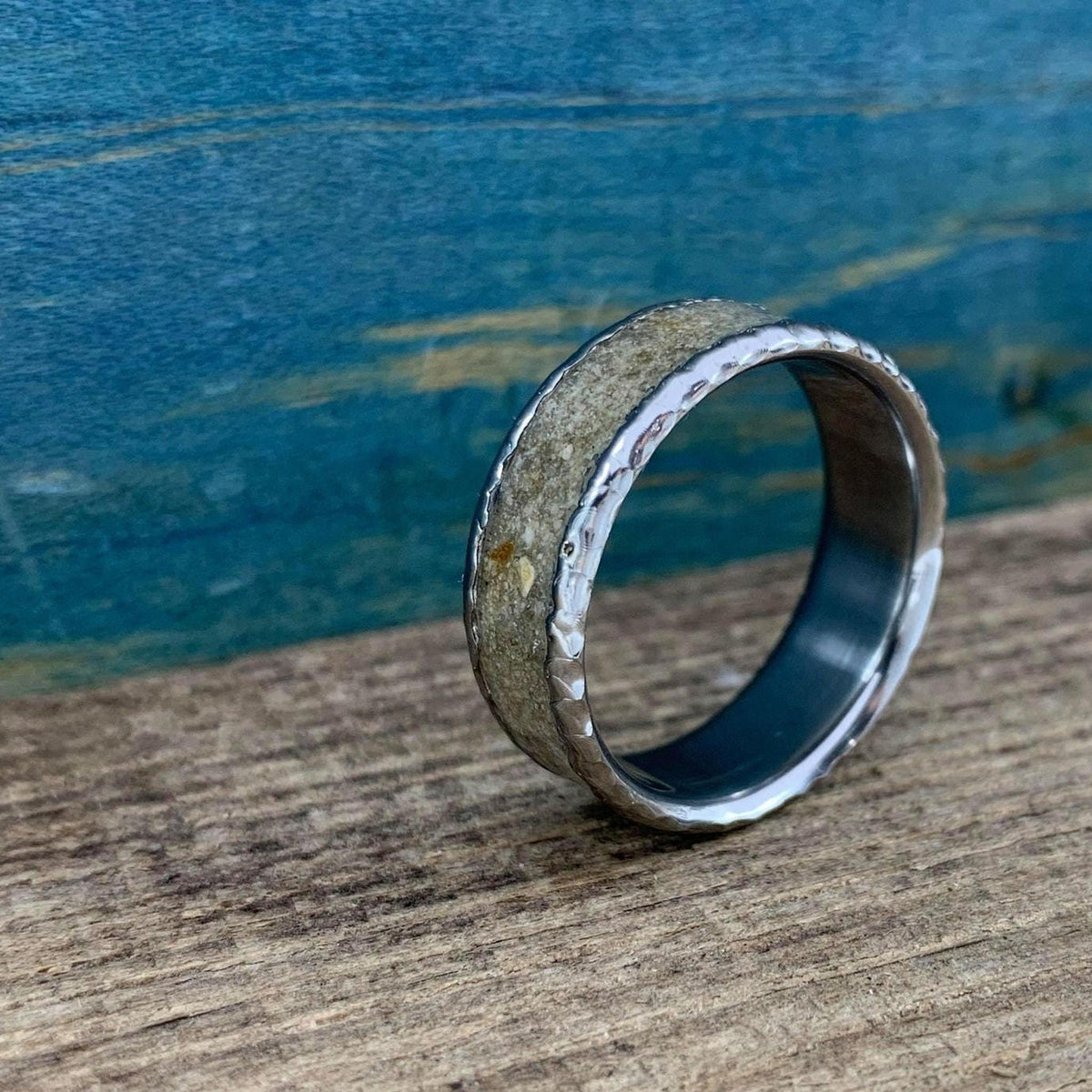 A view of the ring tilted upright with the concrete inlay angled toward the light.