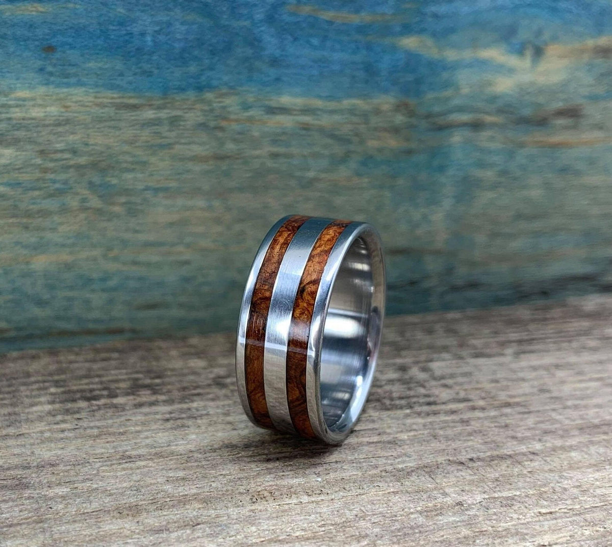 The ring positioned at a three-quarter angle on the rustic wooden surface.