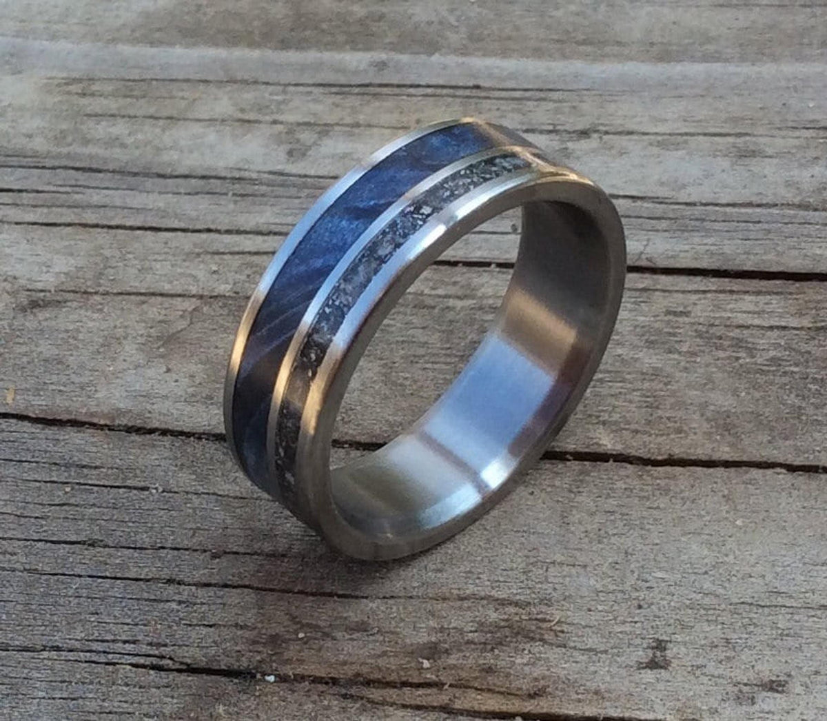 Another angle of the titanium ring with blue wood and meteorite inlay on planks.