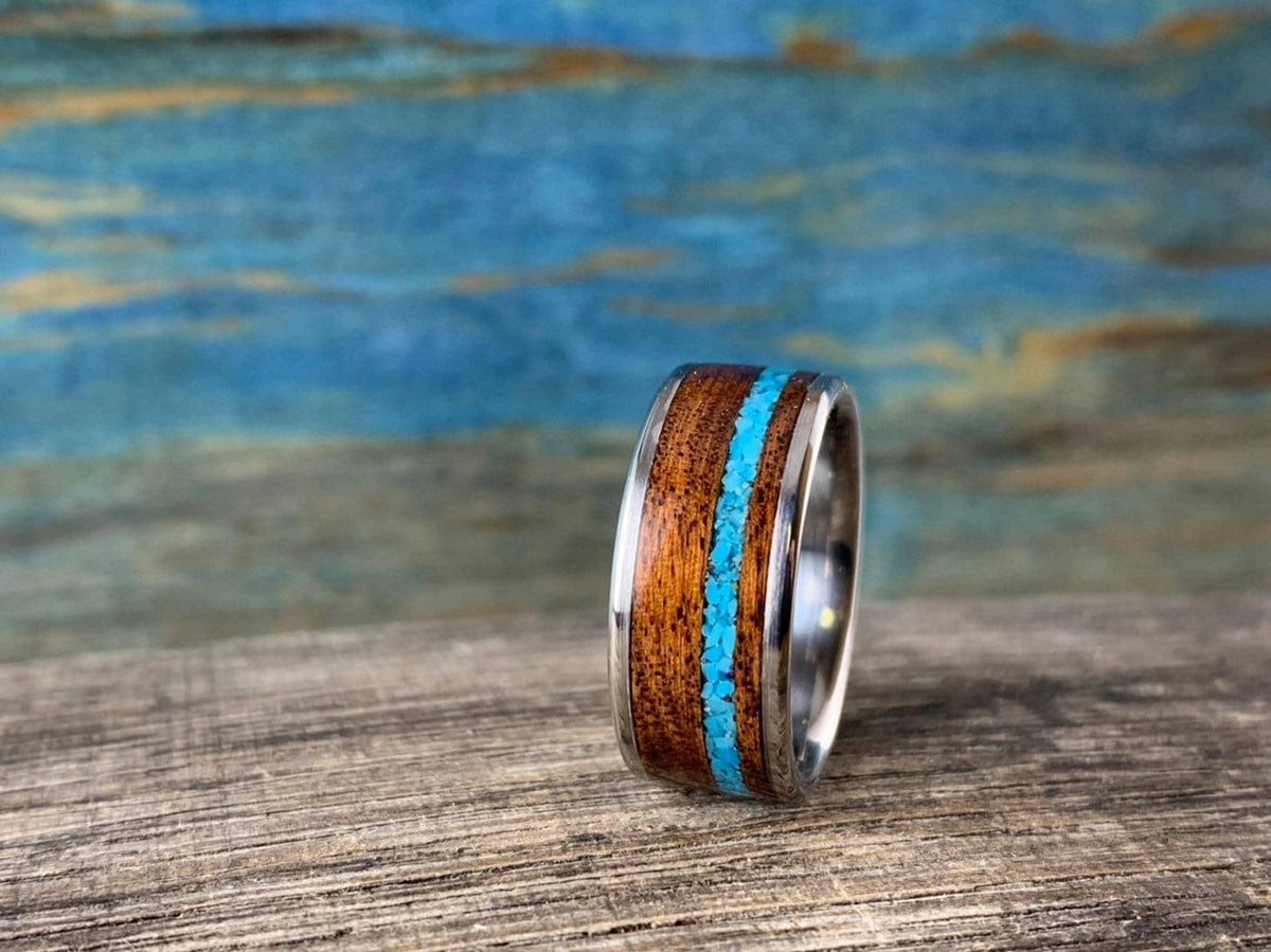 A close-up view of the ring standing vertically on a wooden surface, highlighting the wood grain.