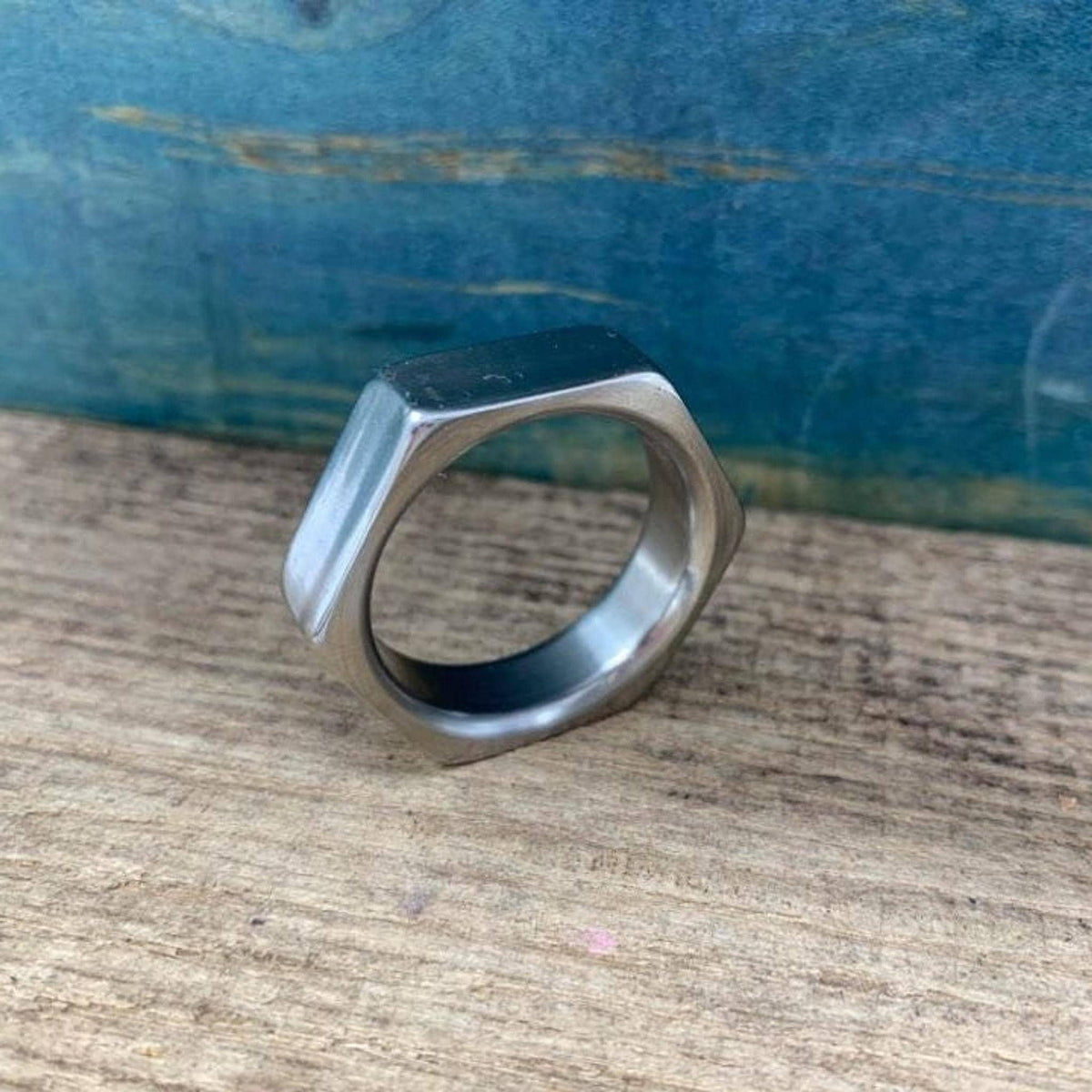 A close-up of the titanium hexagonal nut band showing its machined edges.
