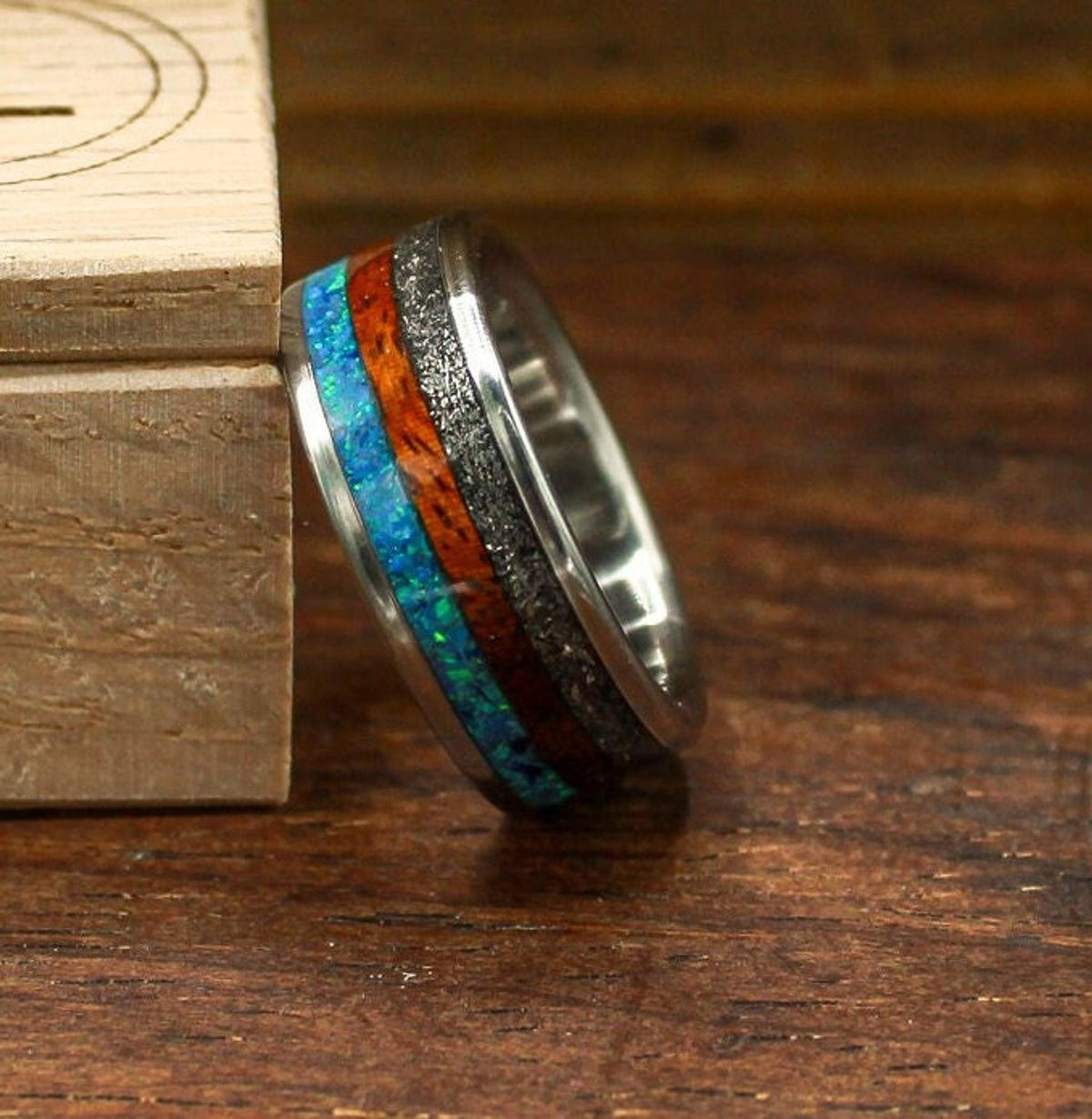 custom made men's titanium ring with Gibeon meteorite, afzelia burl wood, and blue opal inlays