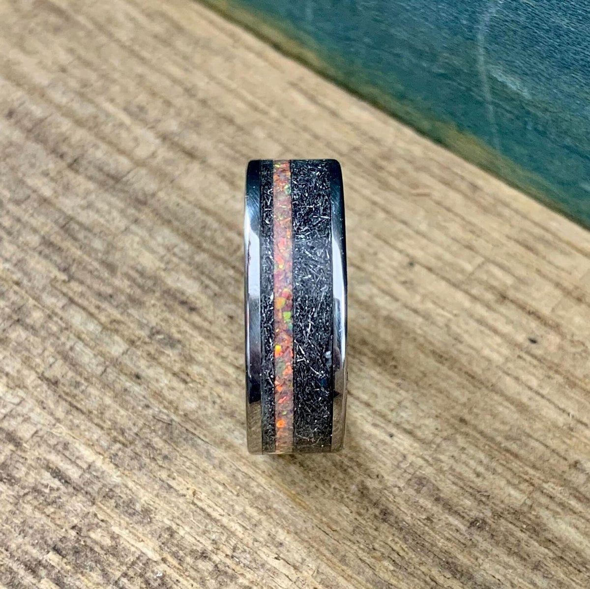 Top-down view of the ring standing vertically on its edge, highlighting the continuous band of meteorite and opal.