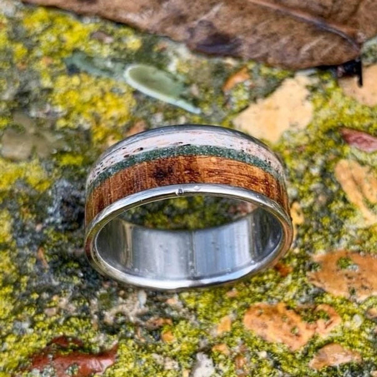 A top-down view of the ring showcasing the horizontal striped pattern of its varied natural inlays.