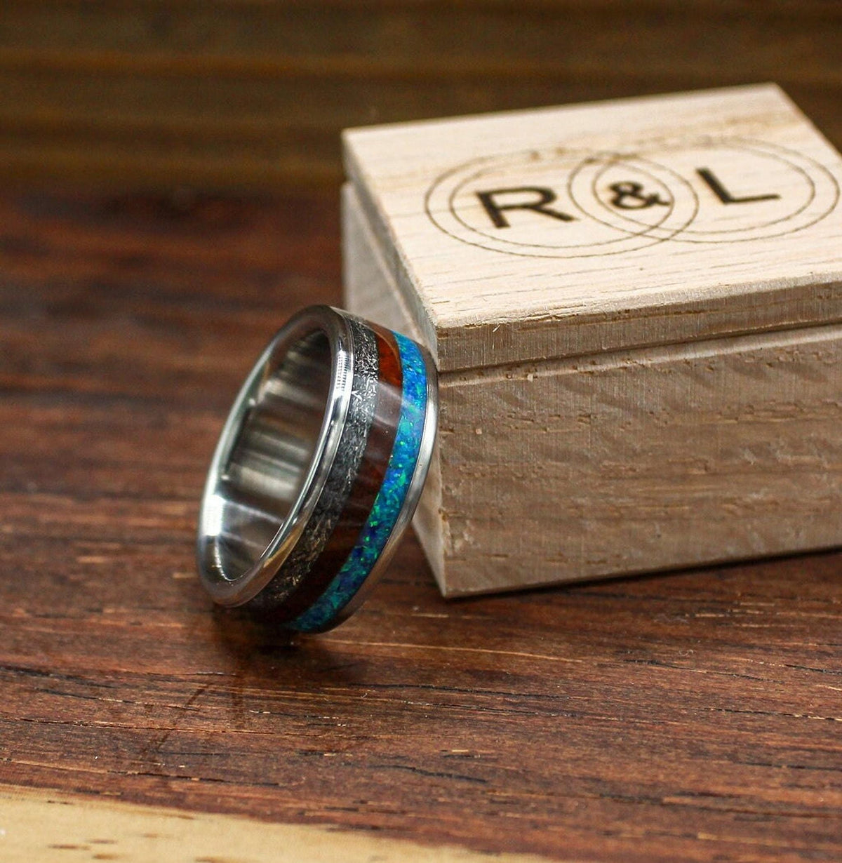 custom made men's titanium ring with Gibeon meteorite, afzelia burl wood, and blue opal inlays