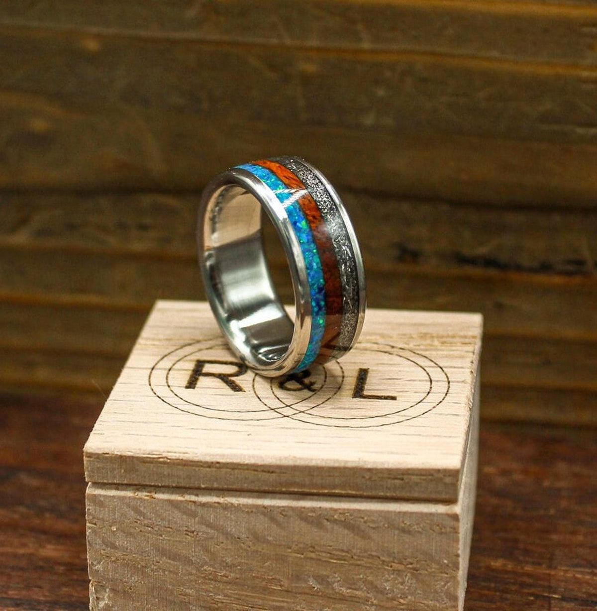 custom made men's titanium ring with Gibeon meteorite, afzelia burl wood, and blue opal inlays