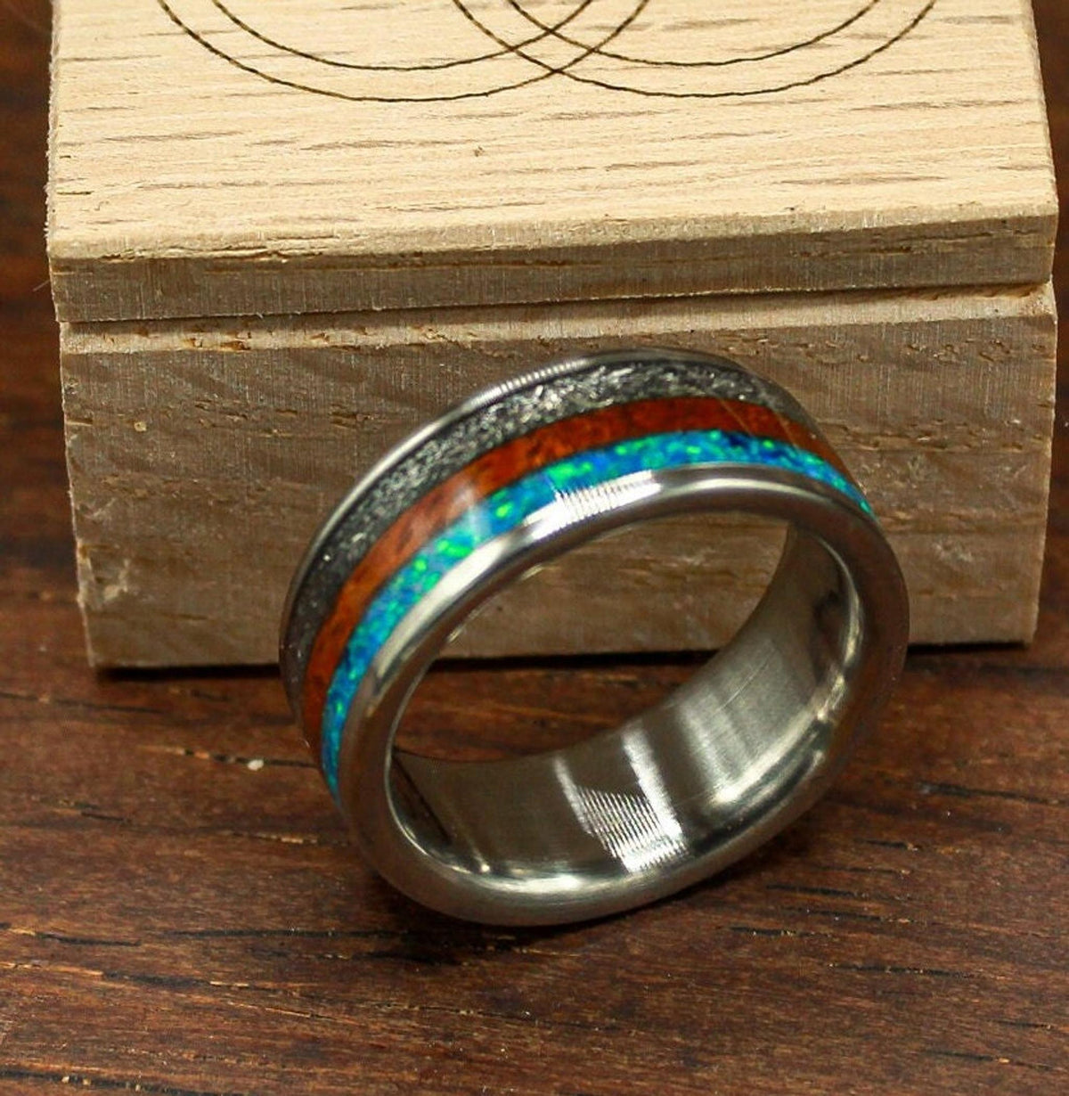 custom made men's titanium ring with Gibeon meteorite, afzelia burl wood, and blue opal inlays