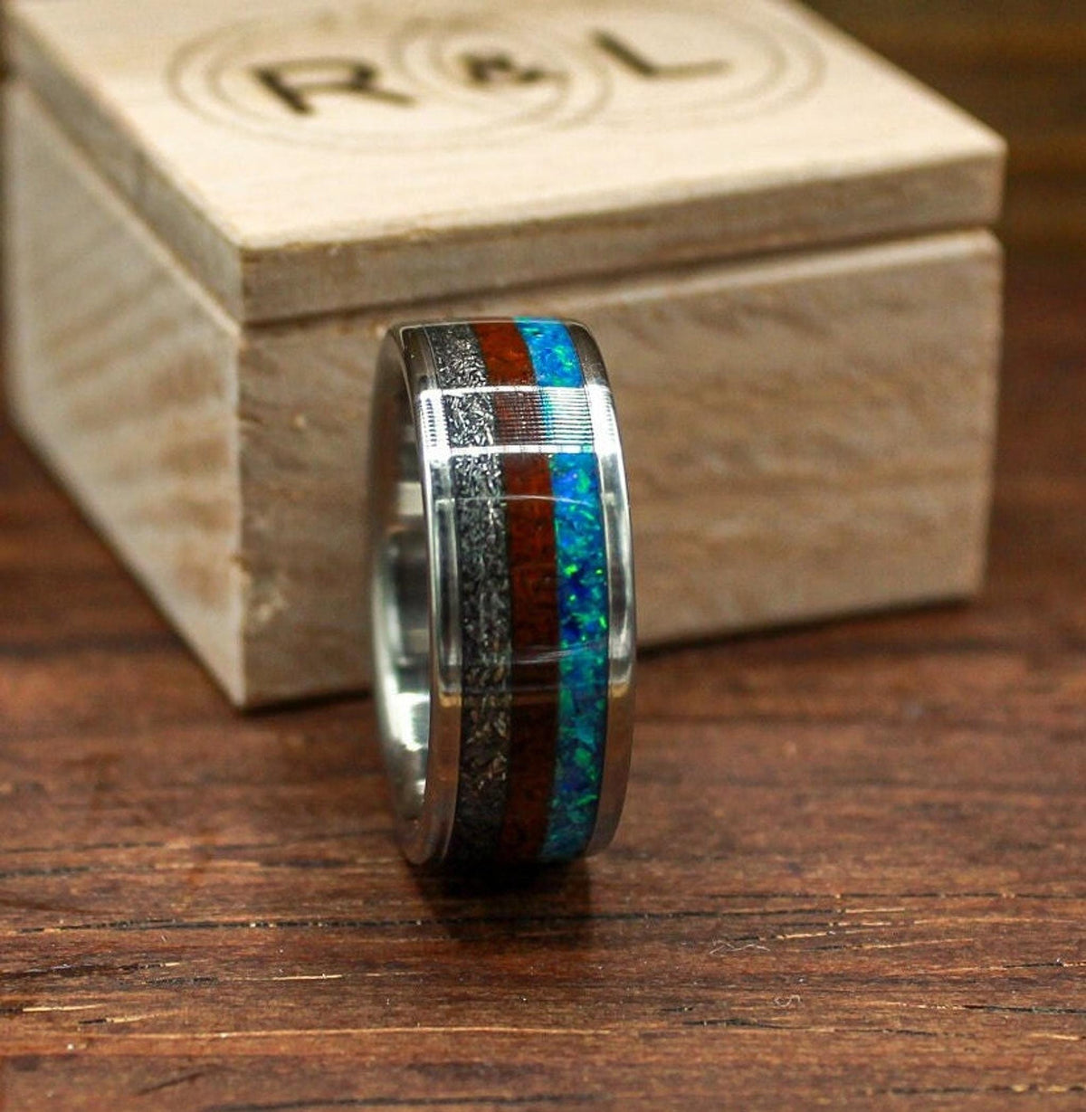 custom made men's titanium ring with Gibeon meteorite, afzelia burl wood, and blue opal inlays