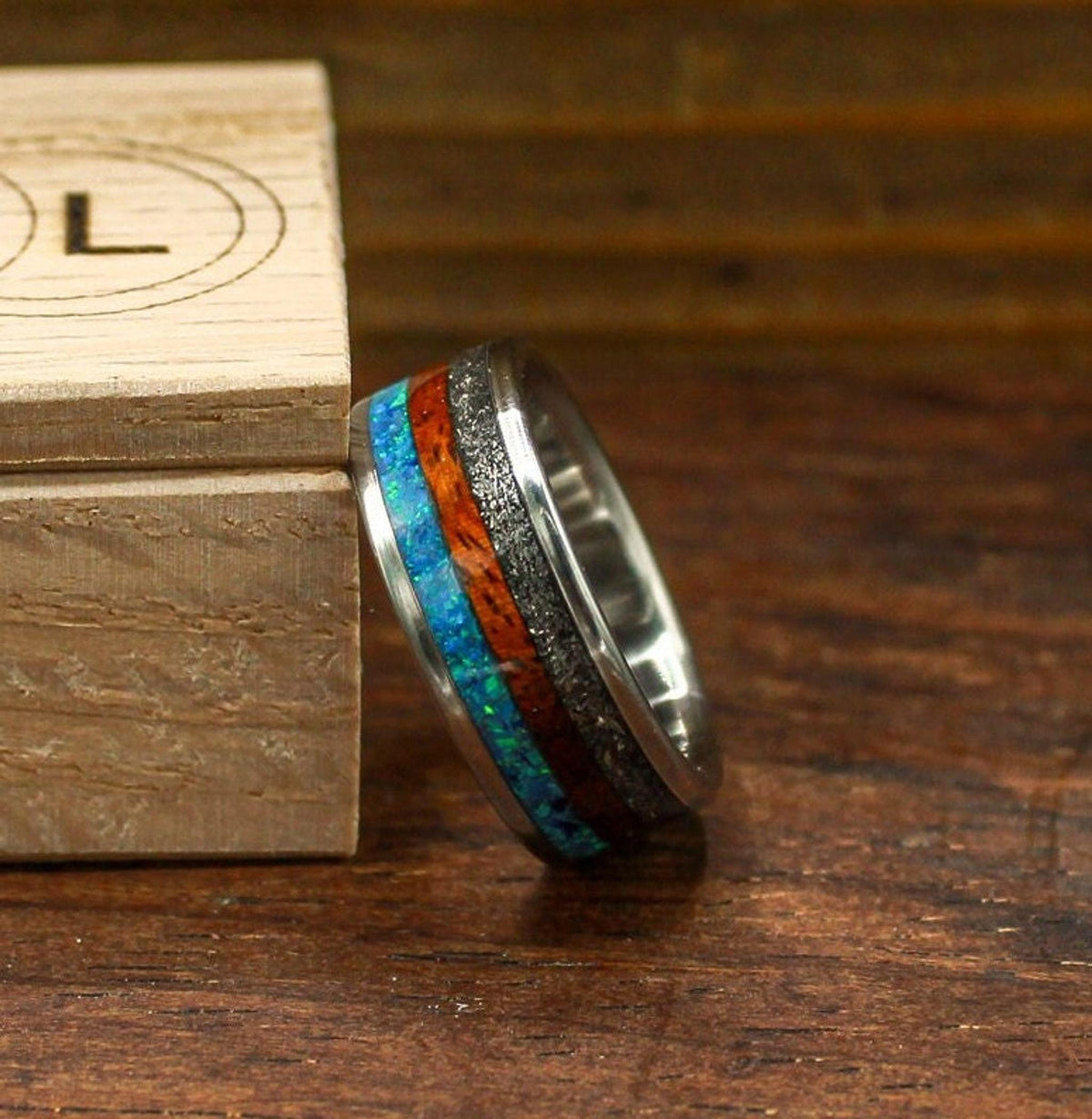 custom made men's titanium ring with Gibeon meteorite, afzelia burl wood, and blue opal inlays