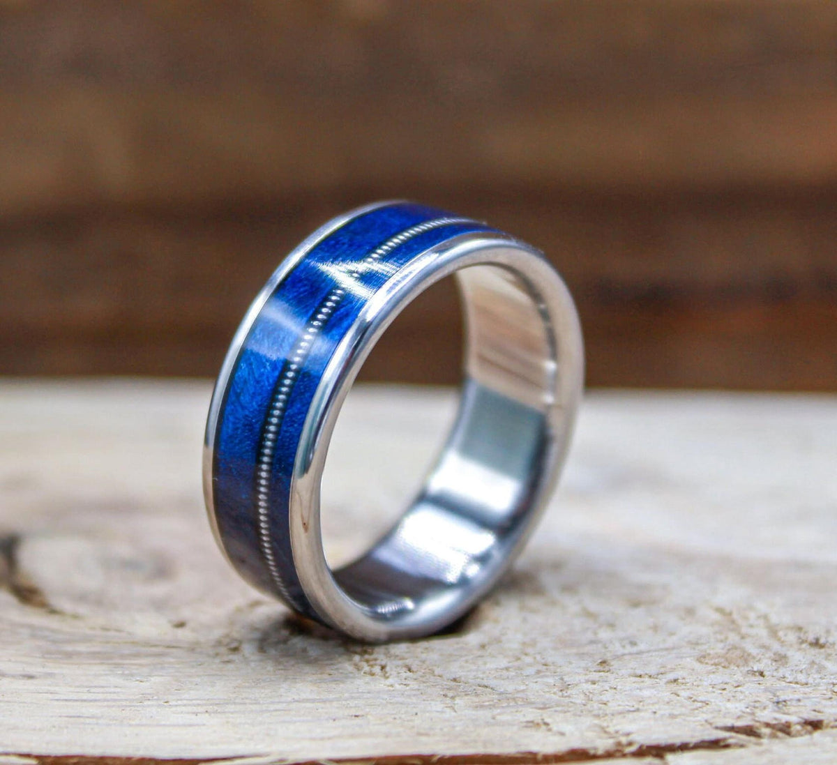 Titanium and blue wood ring for men with guitar string inlay.
