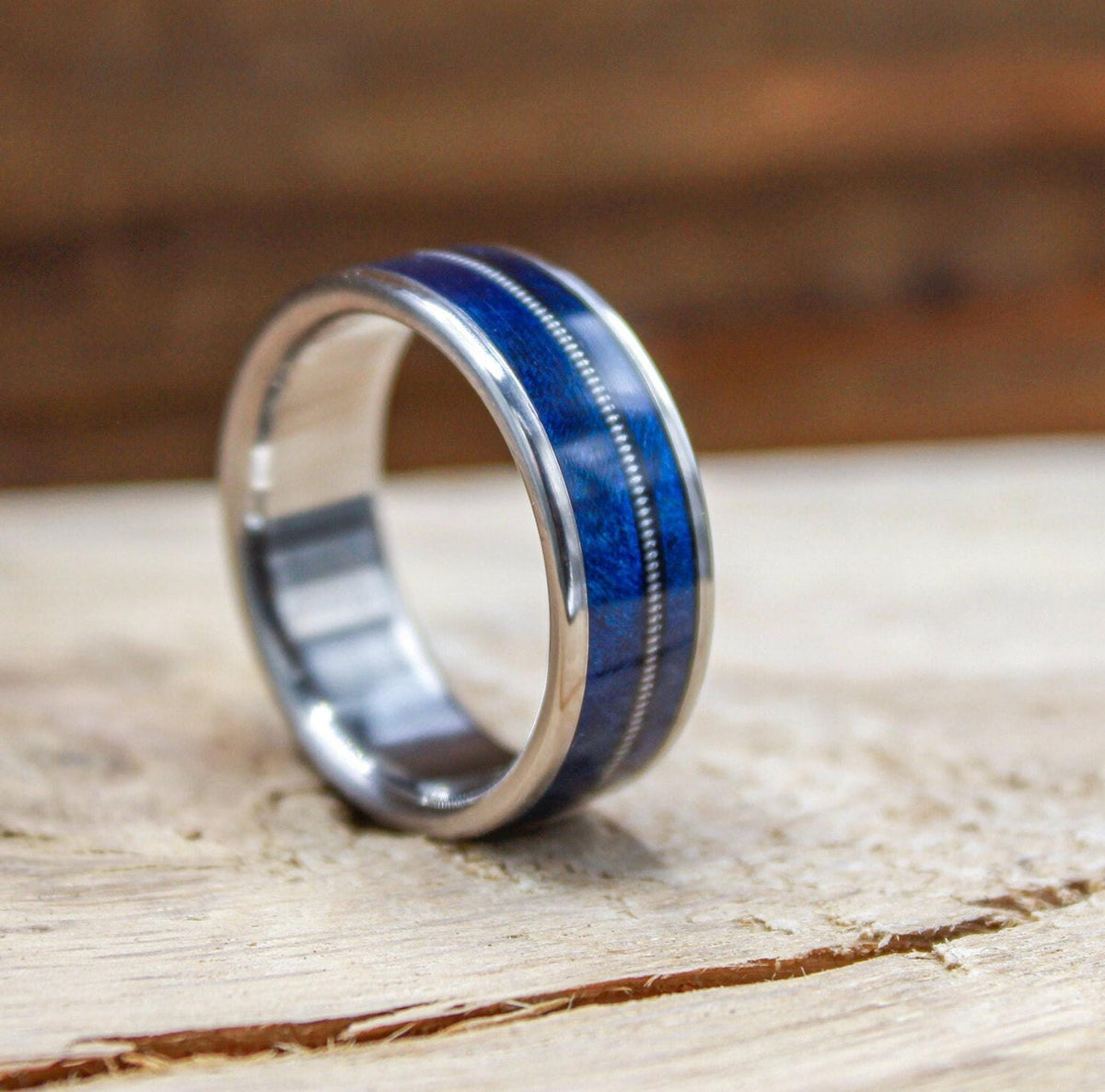 Titanium and blue wood ring for men with guitar string inlay.