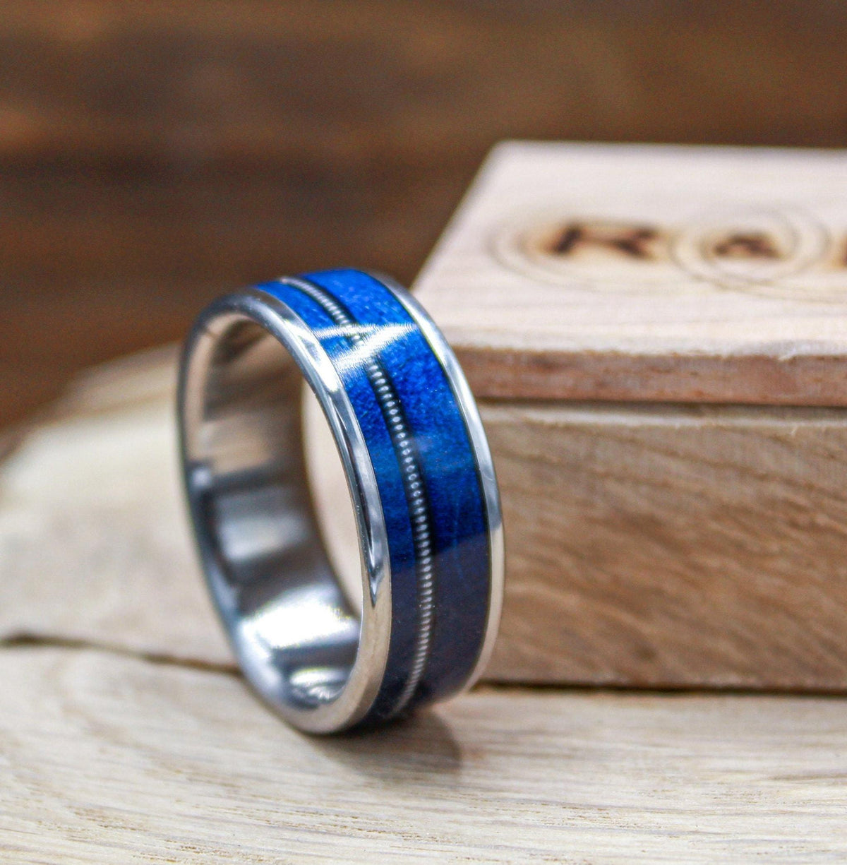 Titanium ring with blue wood and guitar string for men.