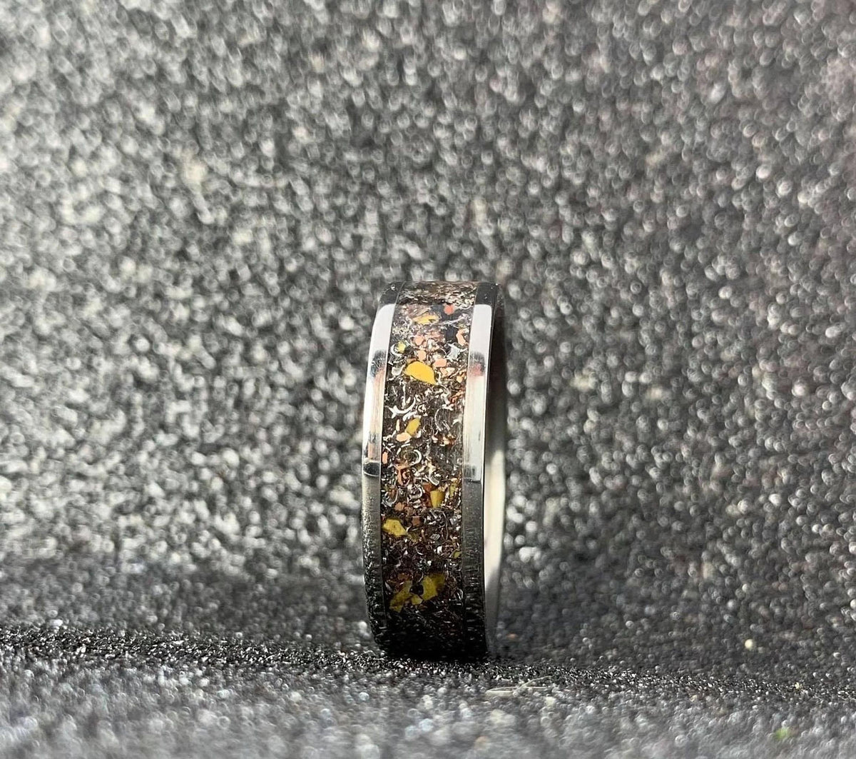 Men's aerospace titanium ring featuring meteorite and dinosaur bone inlay, RobandLean's men's wedding band.