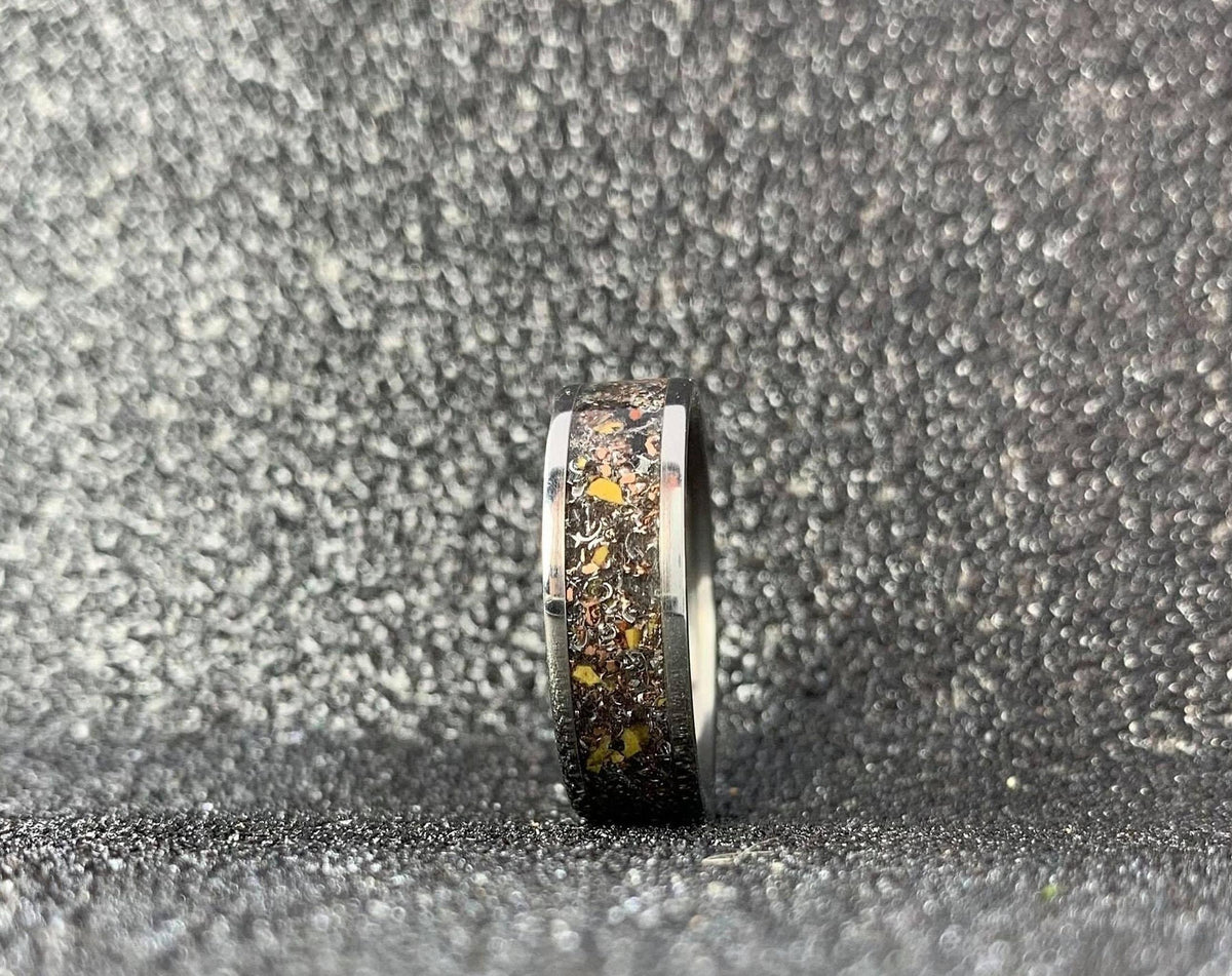 Men's aerospace titanium wedding band with meteorite and dinosaur bone inlay, featuring a sleek design by RobandLean's rings.