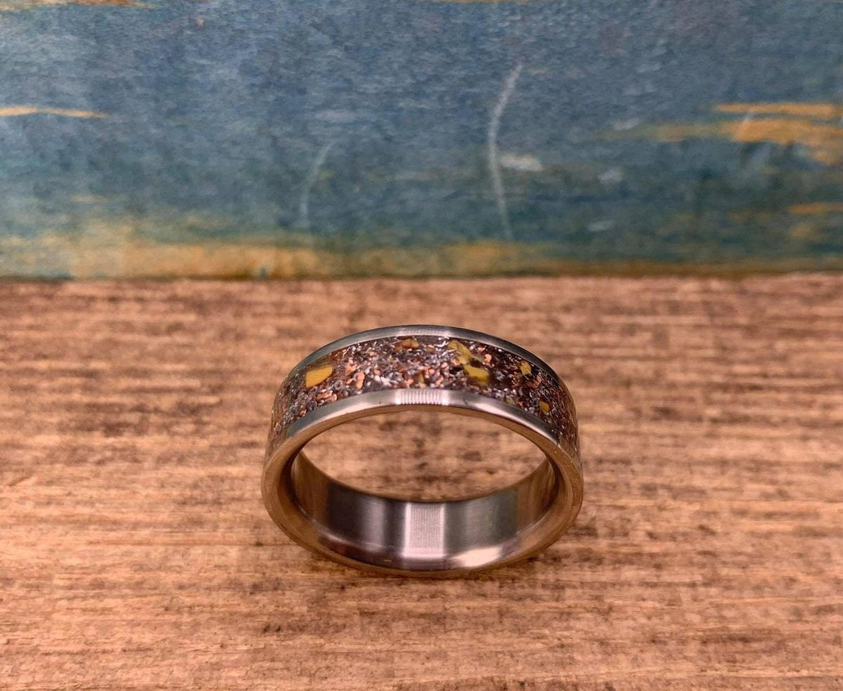 Men's aerospace titanium wedding band featuring meteorite and dinosaur bone inlay by RobandLean's rings.