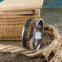 Titanium men's wedding band featuring meteorite, dinosaur bone, and deer antler in a sleek design by RobandLean's rings.
