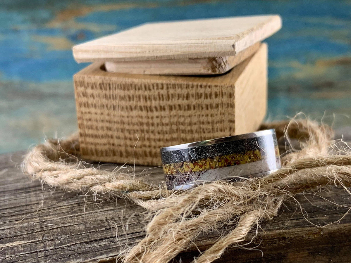 Titanium men's wedding band with meteorite, dinosaur bone, and deer antler inlay, crafted by RobandLean's rings.