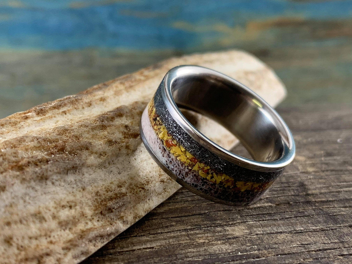 Men's titanium wedding band with meteorite, dinosaur bone, and deer antler inlay, crafted by RobandLean's rings.