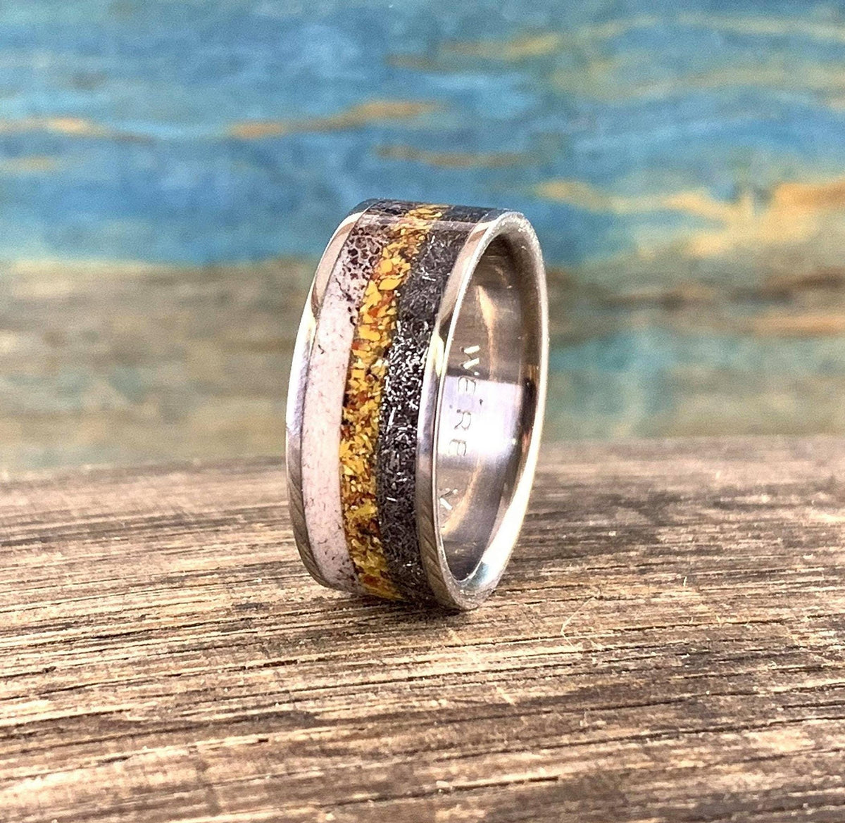 Titanium men's wedding band with meteorite, dinosaur bone, and deer antler inlay, from RobandLean's rings collection.