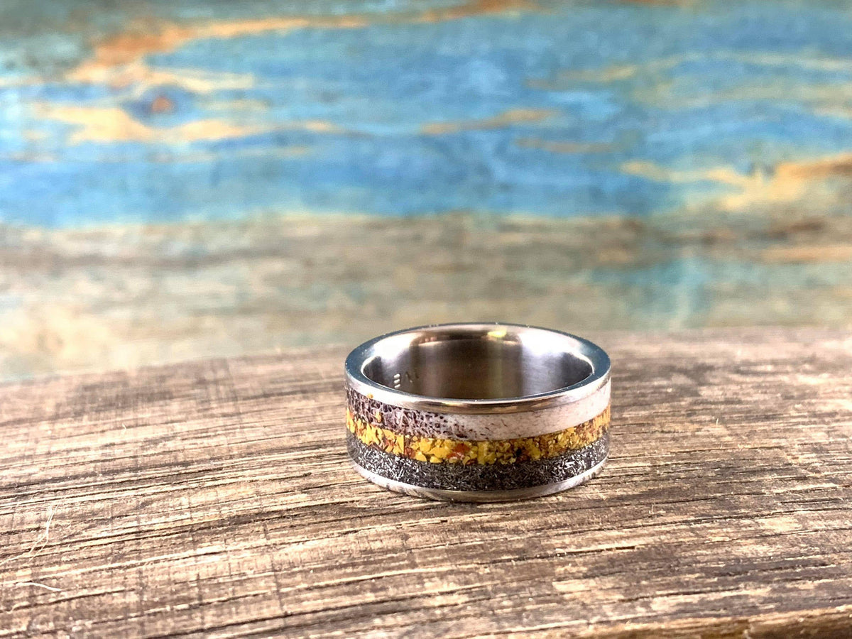 Men's titanium wedding band featuring meteorite, dinosaur bone, and deer antler inlay by RobandLean's rings.