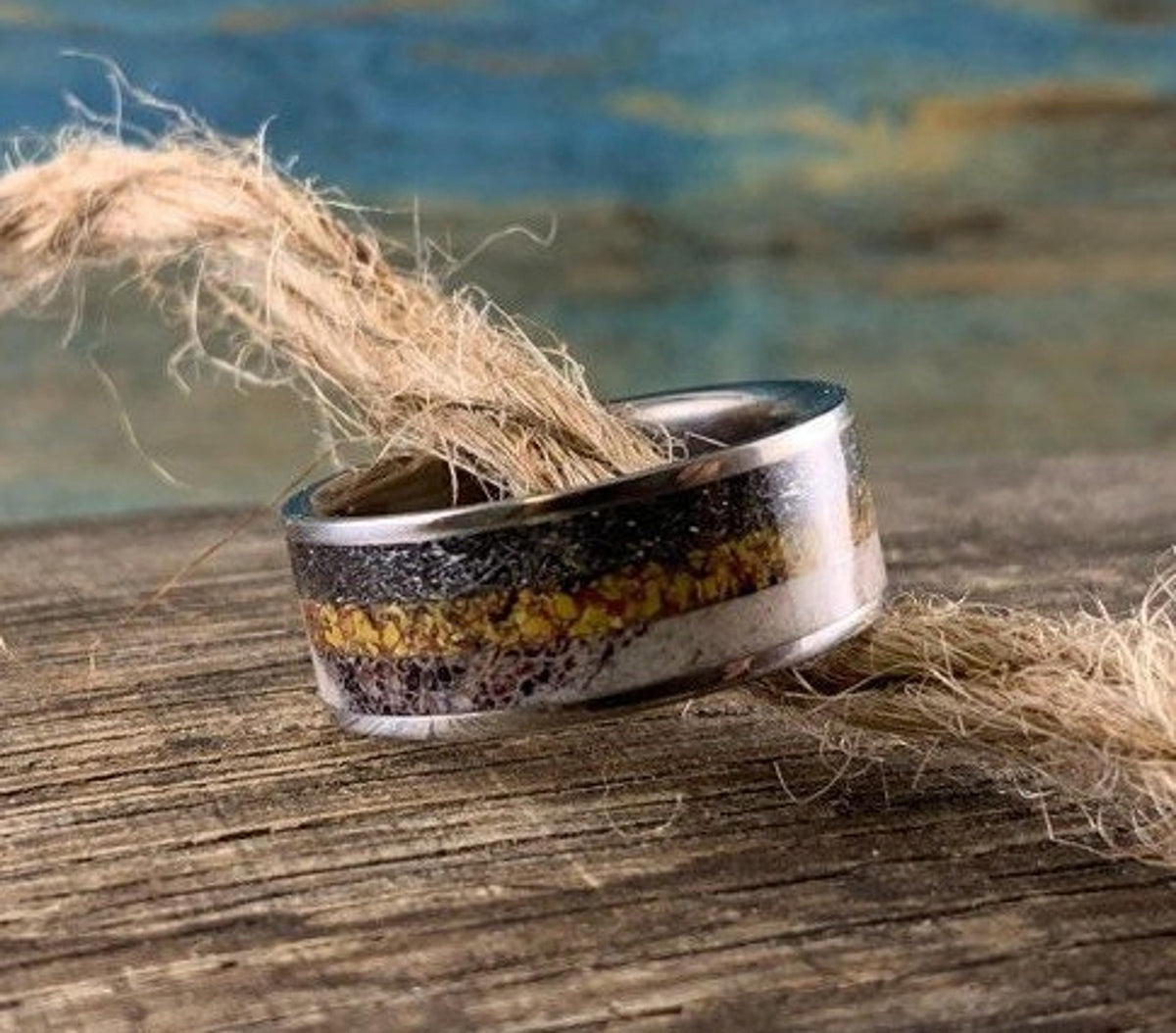 Men's titanium wedding band with meteorite, dinosaur bone, and deer antler inlay, crafted by RobandLean's rings.