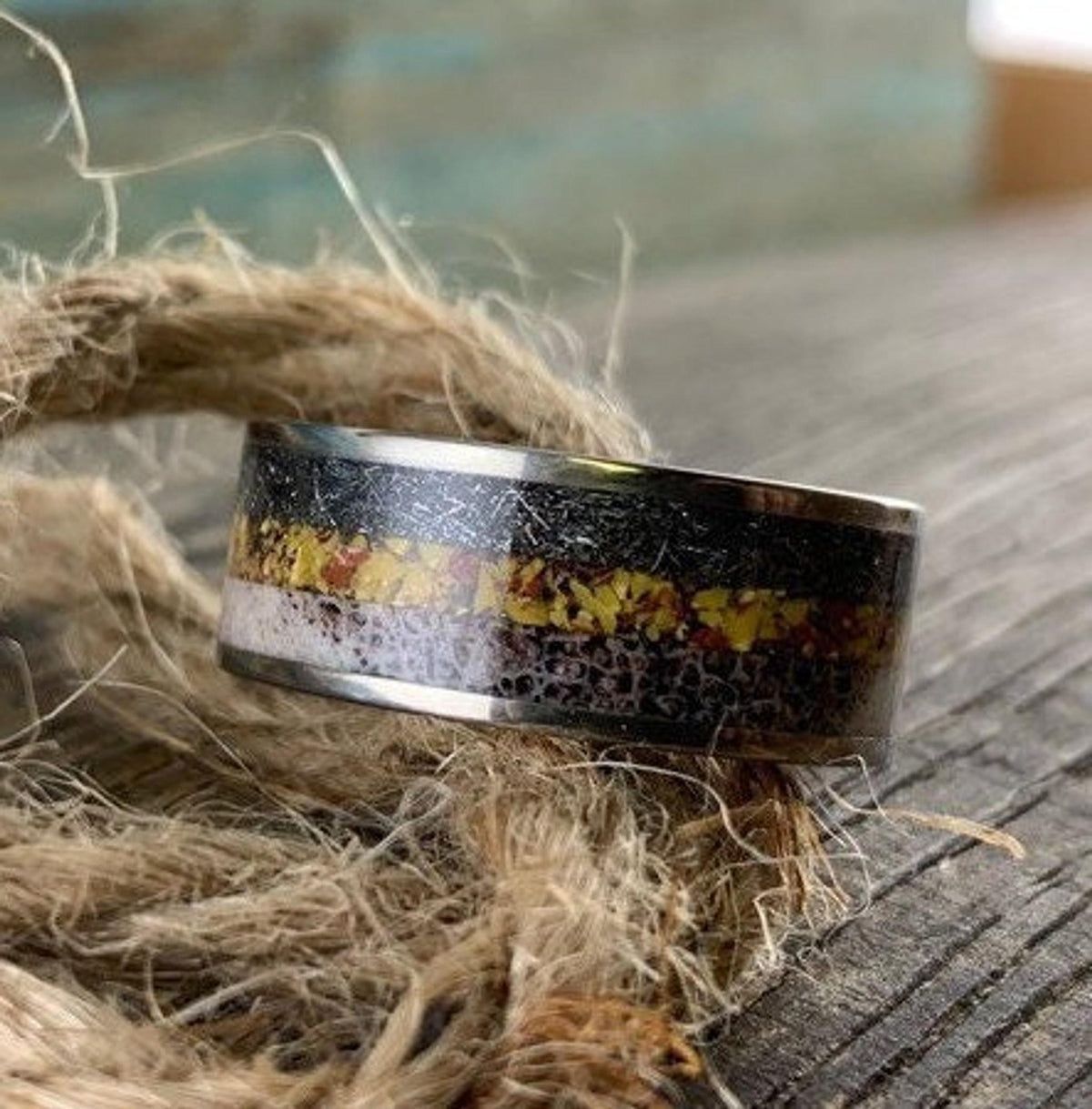 Titanium men's wedding band by RobandLean with meteorite, dinosaur bone, and deer antler inlaid design.