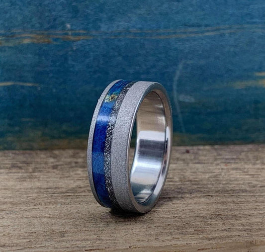 Titanium men's wedding band with meteorite and blue wood inlays, crafted by RobandLean's rings.