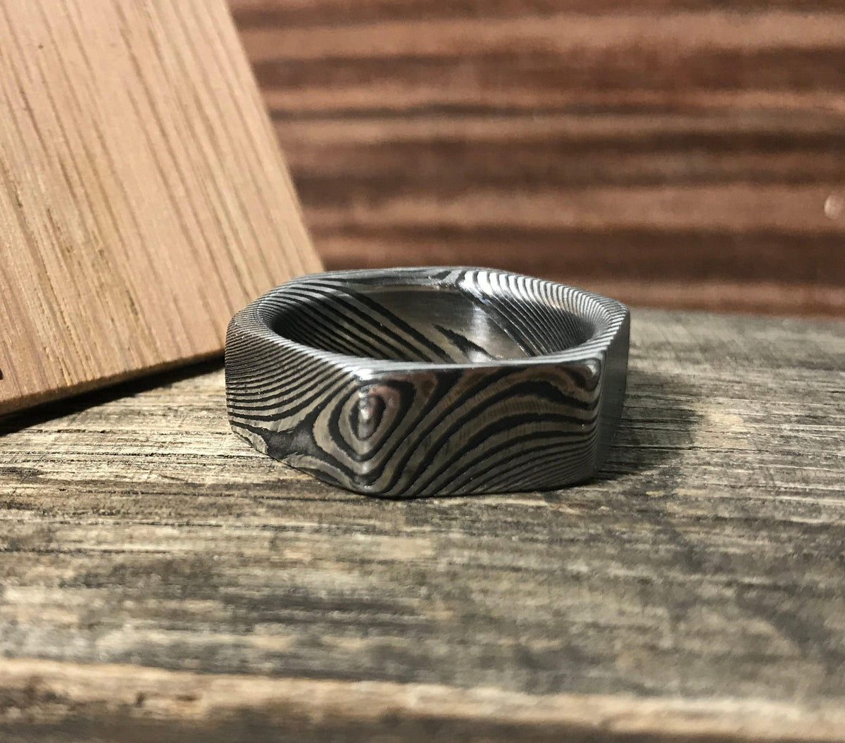 Damascus steel wedding ring with hexagon-cut stainless steel design and comfort fit, from RobandLean's rings collection.