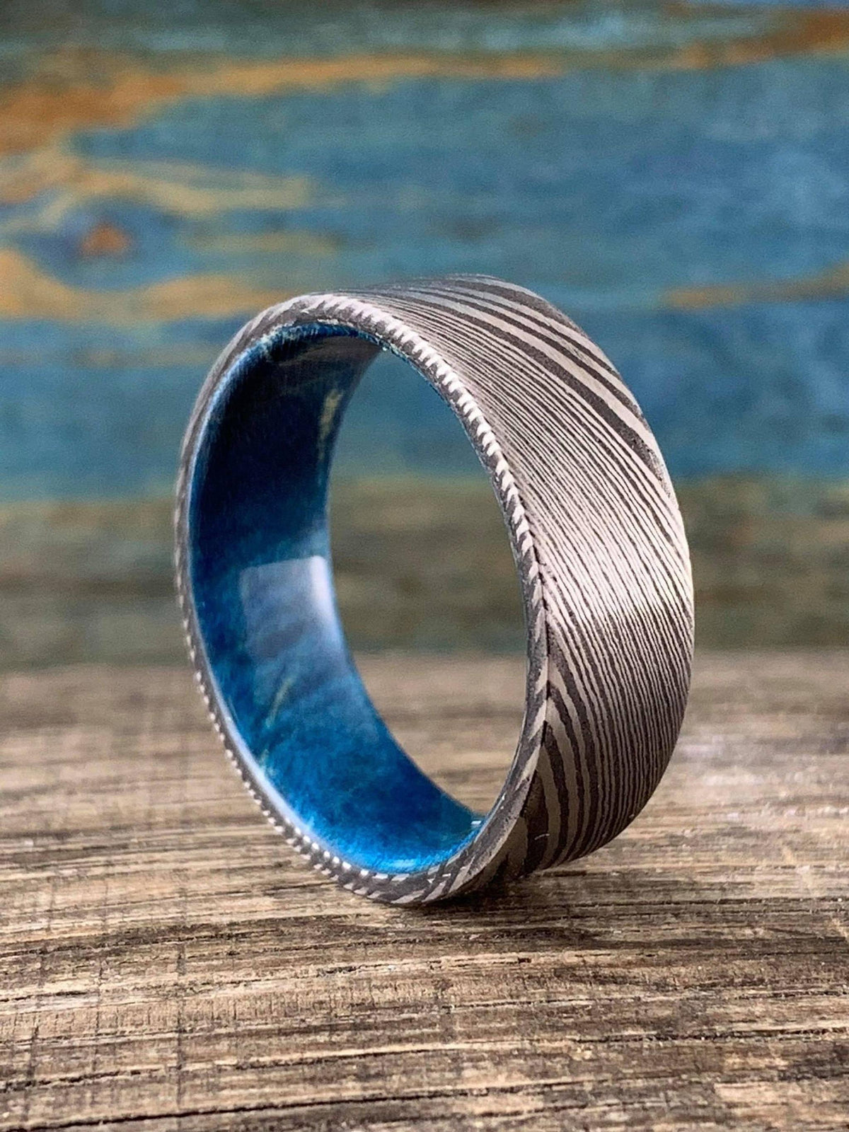 Damascus steel wedding band with blue box elder wood inlay, custom-made RobandLean's rings, 4.5mm width.