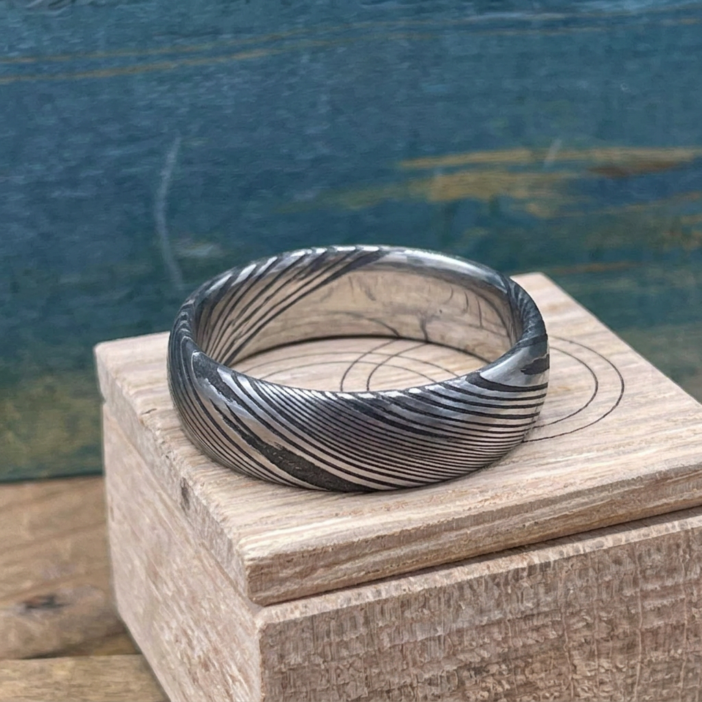 Damascus steel wedding band by RobandLean's rings with a square-shaped, textured, dark metal design perfect for wedding jewelry.