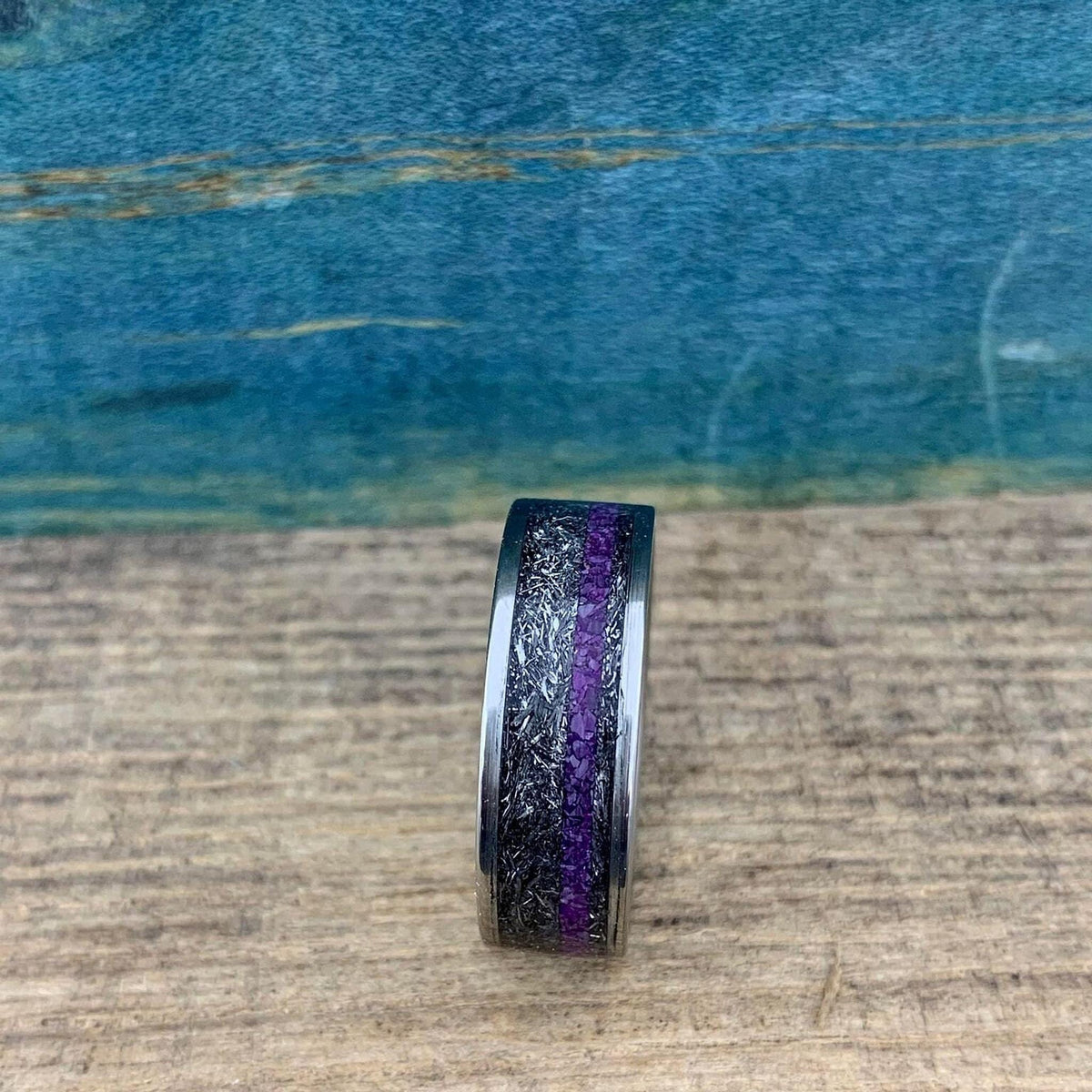 Men's titanium wedding band featuring Gibeon meteorite and purple Sugilite, crafted by RobandLean's rings.