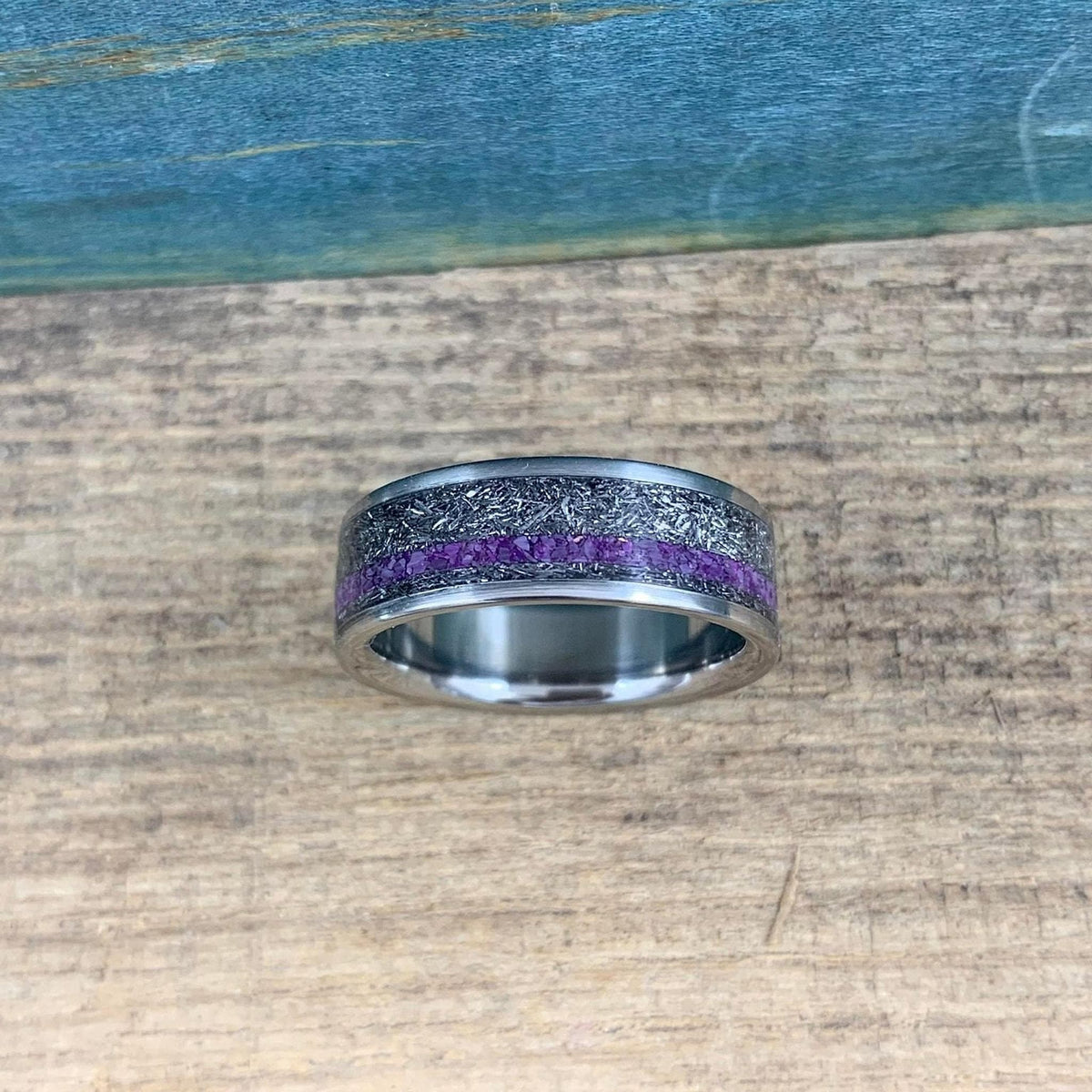 Mens titanium wedding band with Gibeon meteorite and purple Sugilite, featuring a sleek design and ring sizer for perfect fit.