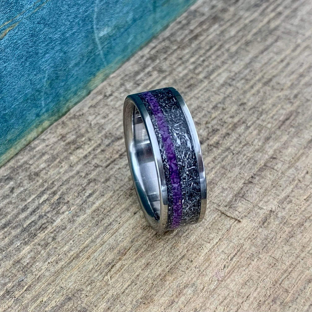 Men's wedding band by RobandLean featuring titanium with Gibeon meteorite and purple Sugilite, showcasing a sleek, modern design.