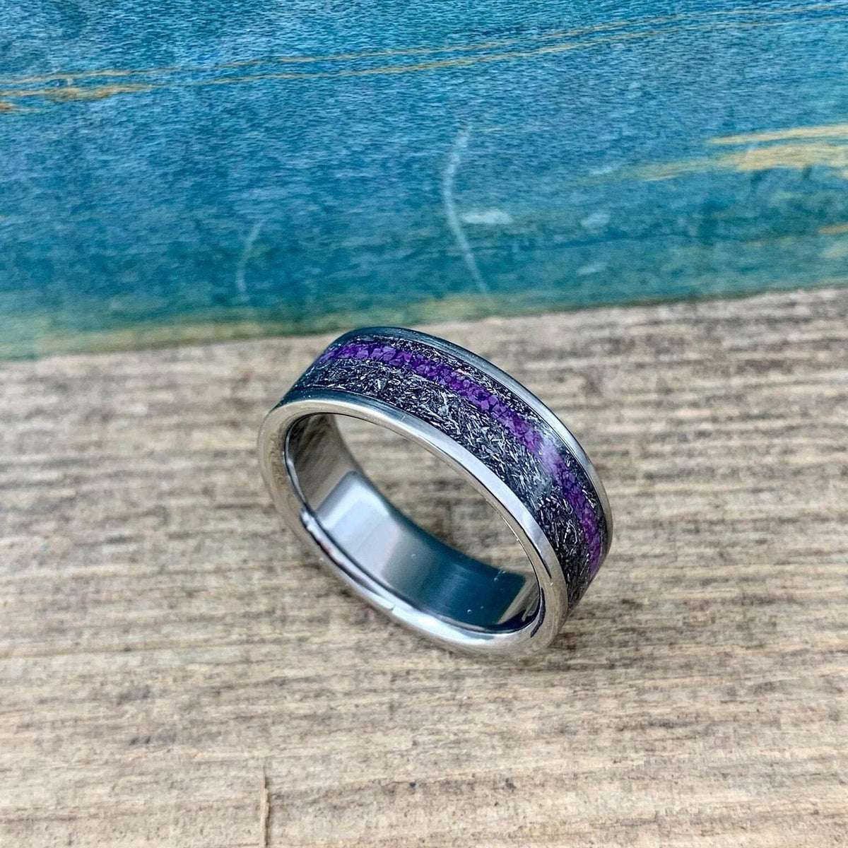 Men's titanium wedding band with Gibeon meteorite and purple Sugilite, featuring a sleek design and polished finish.