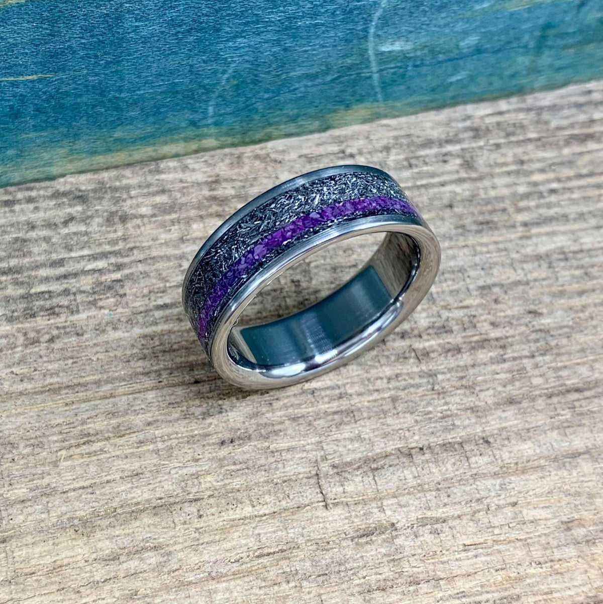 Men's titanium wedding band featuring Gibeon meteorite inlay and purple Sugilite, crafted by RobandLean's rings.