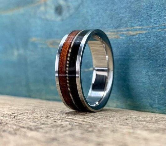 Men's titanium wedding band with rosewood and ebony inlay, featuring a guitar string design, from RobandLean's rings collection.