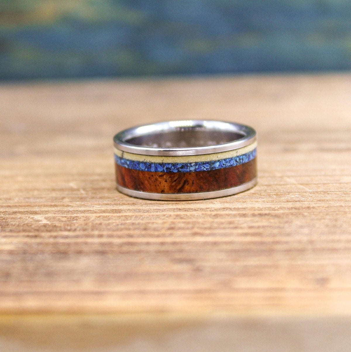 Titanium men's wedding band with Amboyna burl wood and turquoise inlay, crafted by RobandLean's rings.